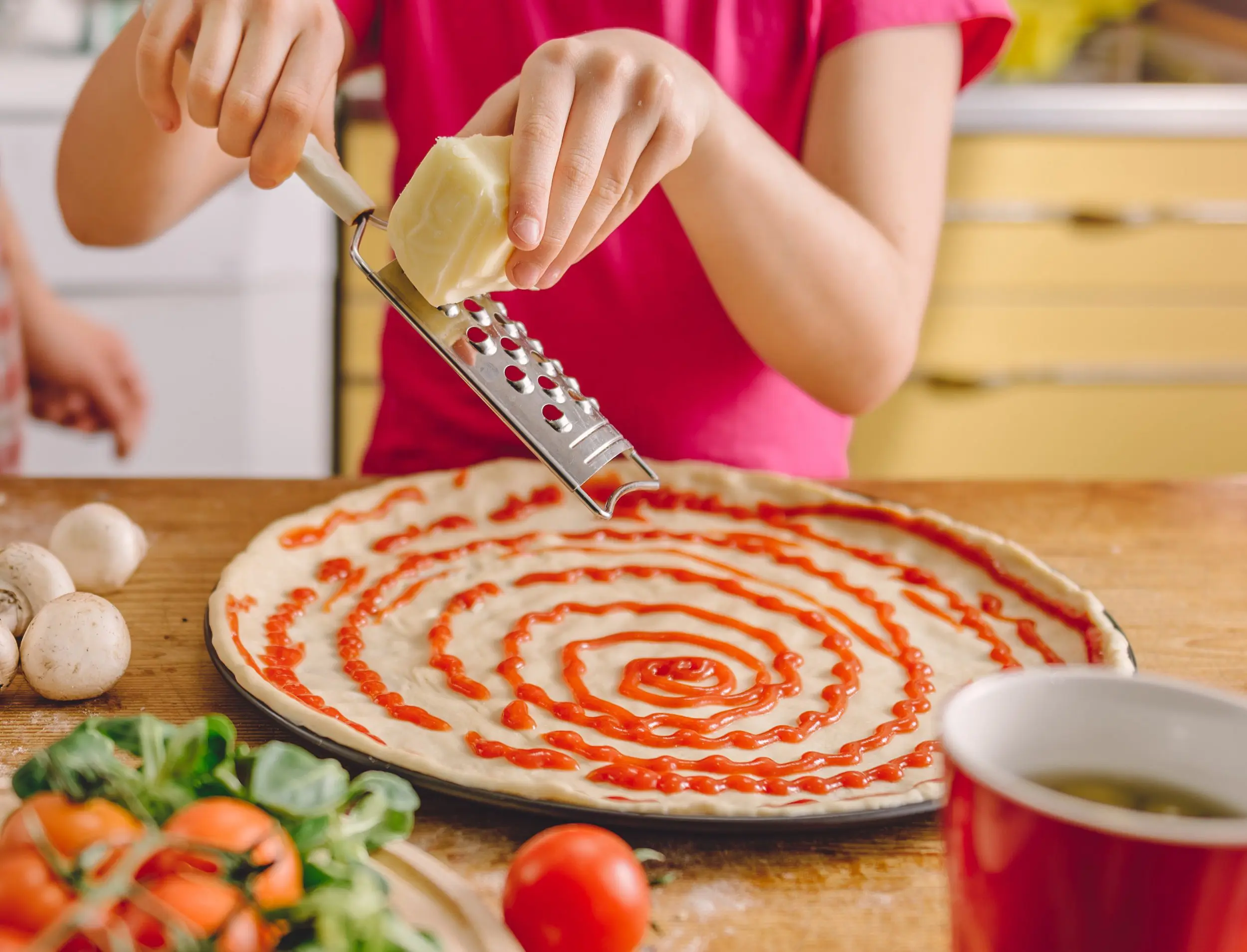 Mother and daughter preparing pizza